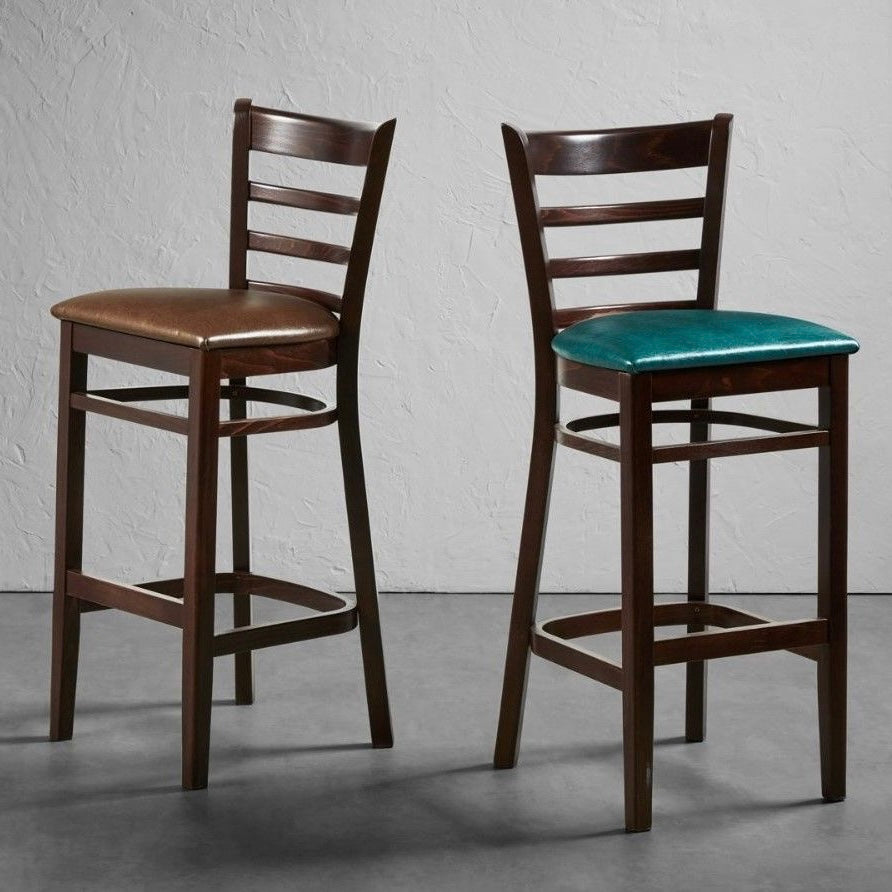 Sheldon bar stools with dark wooden frame and faux leather seat pads.