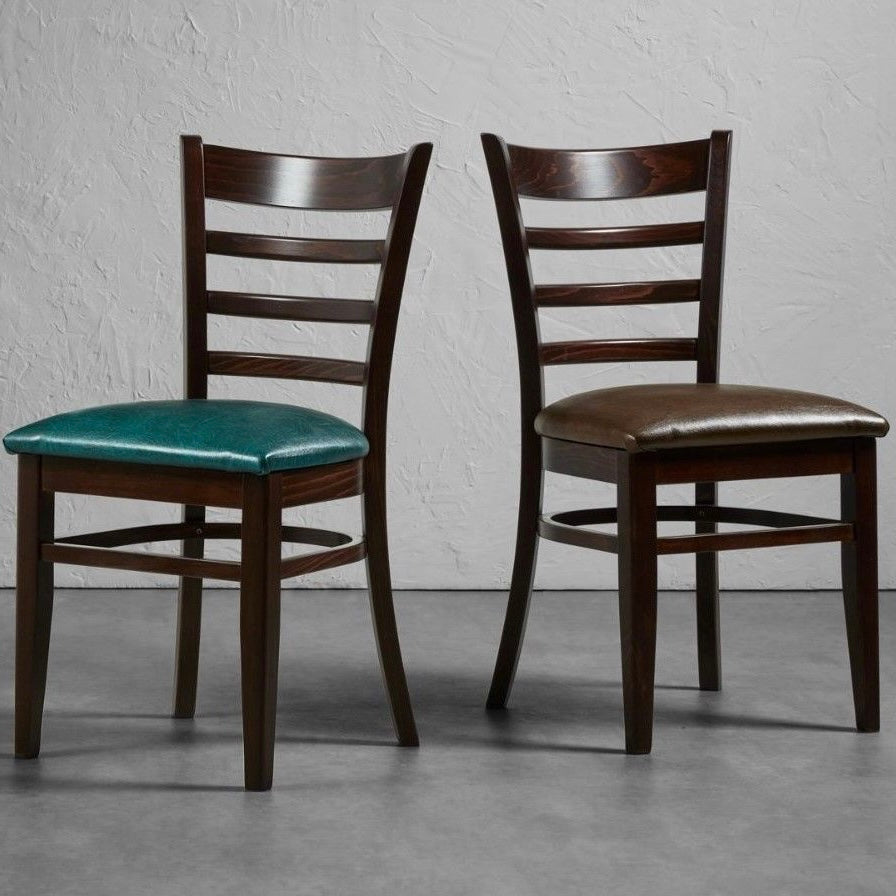 Sheldon side chair with dark wooden frame and faux leather seat pads.